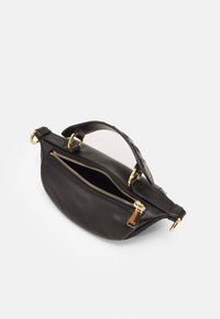 Black leather handbag with a curved shape. It features a top handle, two zippered compartments, and gold-tone zippers and hardware.