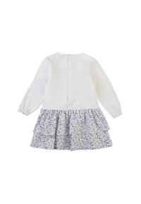 Abito bianco a maniche lunghe con gonna a strati floreale in colori pastello, con chiusura a bottoni sul retro e polsini elasticizzati. Tessuto morbido.