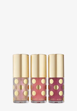 Drie nagellakflessen met gouden stippen en een gouden dop. De kleuren zijn iriserend, roze en dieproze.