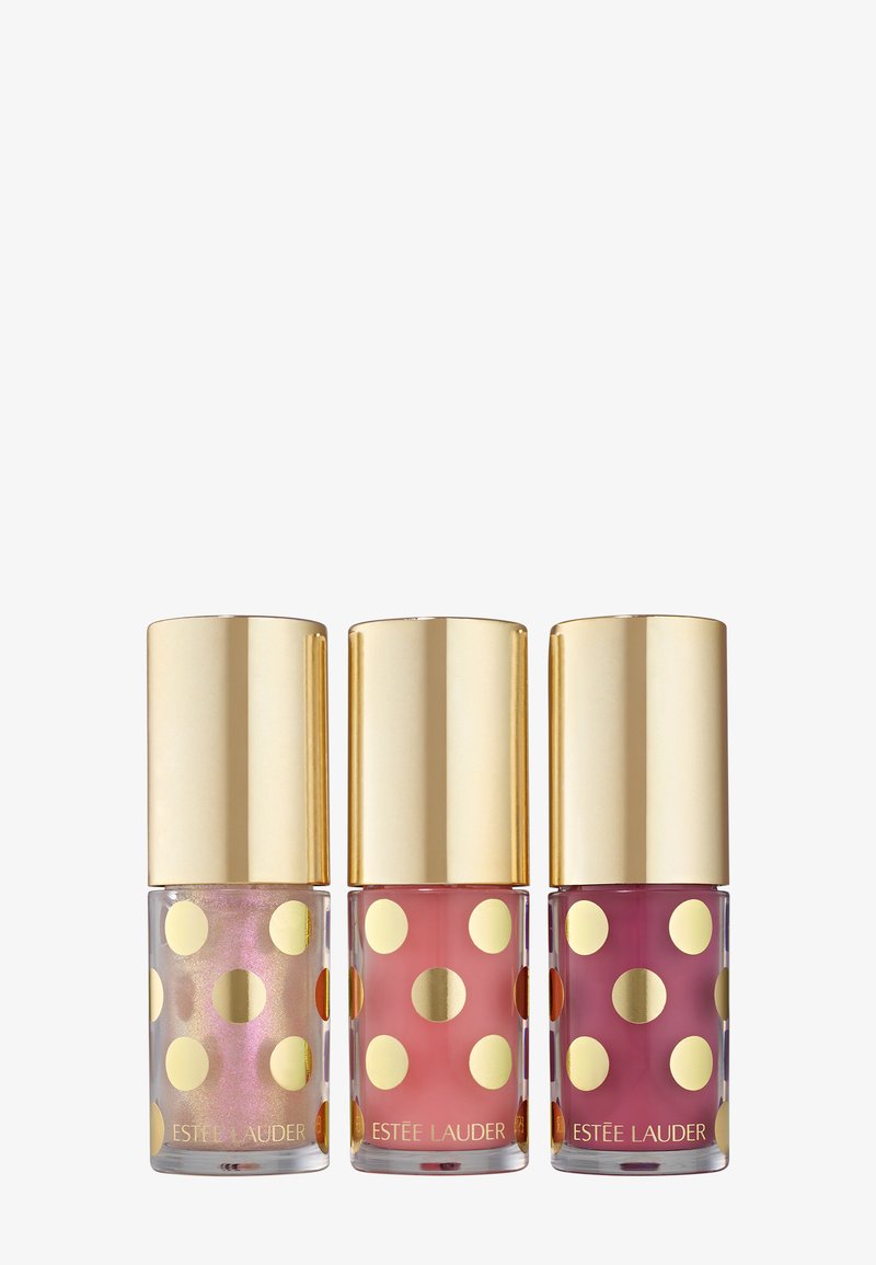 Drie nagellakflessen met gouden stippen en een gouden dop. De kleuren zijn iriserend, roze en dieproze.