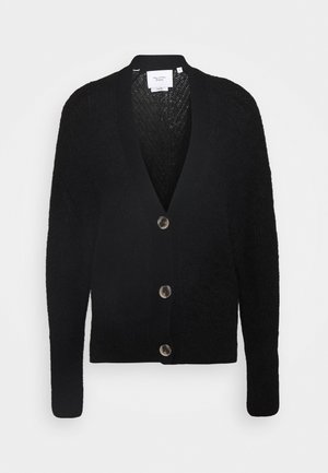 Schwarzer Cardigan aus strukturiertem Strickstoff, mit tiefem V-Ausschnitt, langen Ärmeln und fünf kontrastierenden Knöpfen vorne.