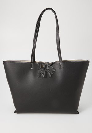 Black leather tote bag with a textured finish, featuring a logo emblem in the center and contrasting stitching. Two long handles for carrying.