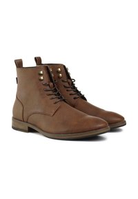 Brown leather ankle boots featuring a smooth finish, rounded toe, lace-up front, and decorative brass-tone studs on the upper.