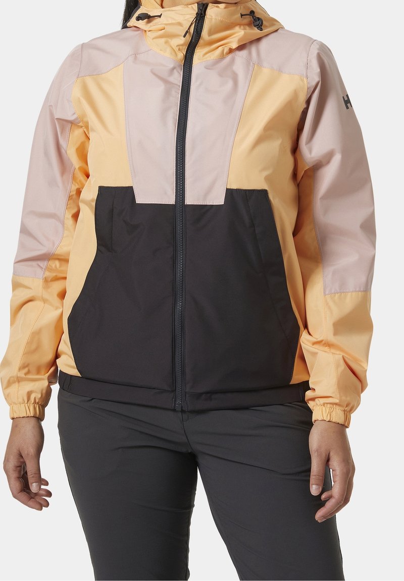 Färgglad huva-jacka med en design i gult och svart färgblock. Tillverkad av lätt och vattenavvisande material med elastiska ärmslut och dragkedjestängning.