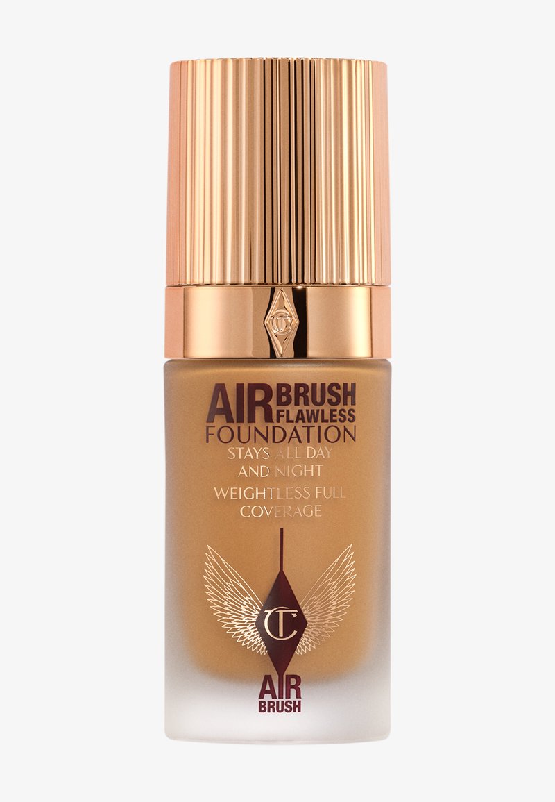 Air Brush Flawless Foundation in einer Glasflasche mit einem verzierenden goldenen Deckel. Verfügt über ein Farbverlauf-Design, mit Text über schwerelose Vollabdeckung.