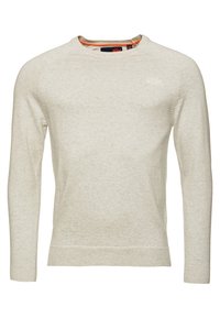 Maglione beige chiaro a collo rotondo realizzato in tessuto morbido. Maniche lunghe, polsini e orlo a coste, con un discreto dettaglio del logo sul petto.