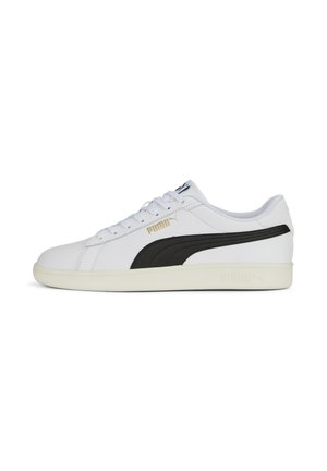 White sneakers with a black PUMA stripe, featuring a smooth leather finish, round toe, and a textured cream sole. Gold accents on the side.