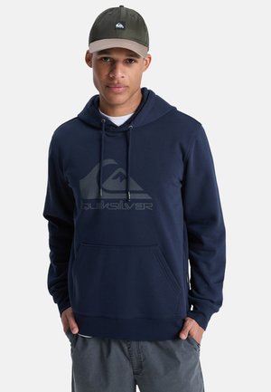 Navy blue hoodie in soft fabric with a kangaroo pocket and drawstrings. Features a large, subtle logo on the front, complemented by gray accents.