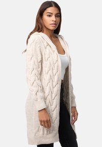 Tjockstickad cardigan i krämfärg, med en huva, långa ärmar och sidofickor. Strukturerad mönster med en lös passform.