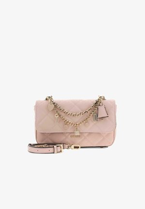 Sac à main matelassé rose clair Guess avec chaîne en or, breloques, détail de serrure et bandoulière amovible sur fond blanc.