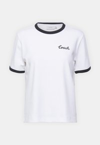 White cotton t-shirt with black ringer collar and cuffs. Features embroidered "Coach" logo on the chest. Short sleeves, relaxed fit.