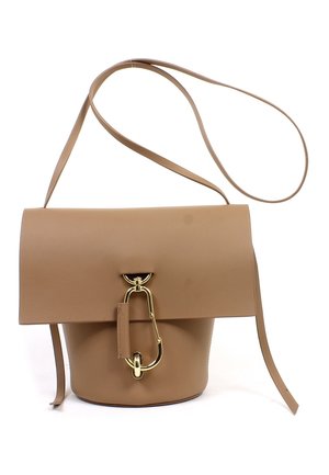 Tan leather bucket bag with long strap and distinctive large gold clasp fastening on front flap.