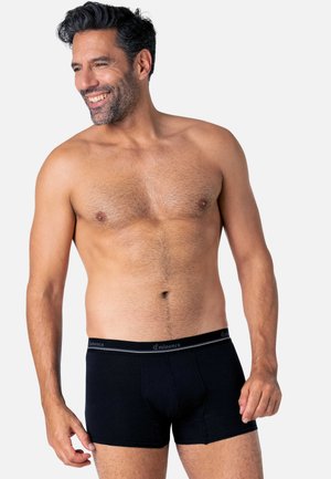 Boxers pour hommes noirs en tissu doux, dotés d'une ceinture lisse affichant le logo "Eminence" et d'une coupe ajustée.