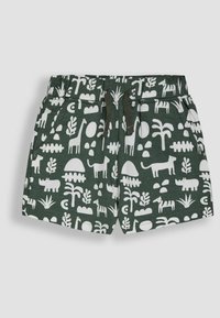 Shorts en coton vert avec un motif blanc d'animaux et de plantes, une taille élastique et des poches latérales.