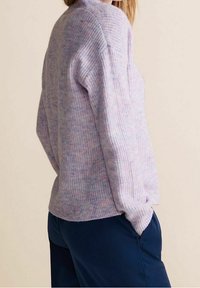 Light purple knitted sweater with a textured pattern, drop shoulder design, and ribbed cuffs. Paired with navy-colored bottoms.