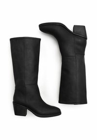 Botas de cuero negras hasta la rodilla con tacón cuadrado, textura suave, líneas limpias y punta redondeada, con un detalle de costura lateral.