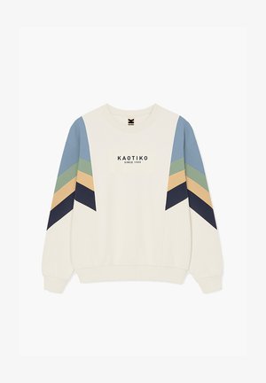Felpa cremosa con strisce a chevron blu, verde, beige e blu navy sulle maniche, e "KAOTIKO SINCE 1999" stampato al centro davanti.