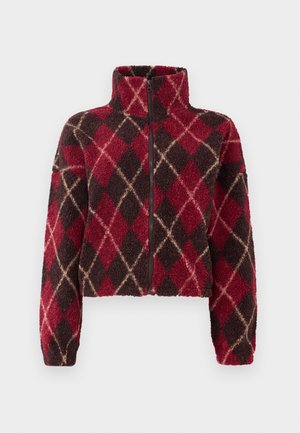 Fleece jacket with high collar, zip front, and diamond pattern in red, brown, and cream. Cropped design; textured, warm fabric.