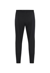 Pantalon de sport noir avec une taille élastique arborant le nom de la marque "JAKO". Le design est ajusté avec des poignets aux chevilles. Texture lisse.