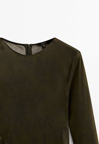 Olive green long-sleeve top with a round neckline and a back zipper. Smooth texture with a slight sheen. Simple and modern design.