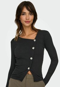 Chemise noir à manches longues à côtes avec un décolleté carré, présentant cinq boutons argentés sur le devant et un détail de ourlet torsadé.