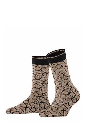 Beige Knöchelsocken mit einem schwarzen Blumenmuster, die einen einfarbigen schwarzen Bund und eine glatte Textur aufweisen.