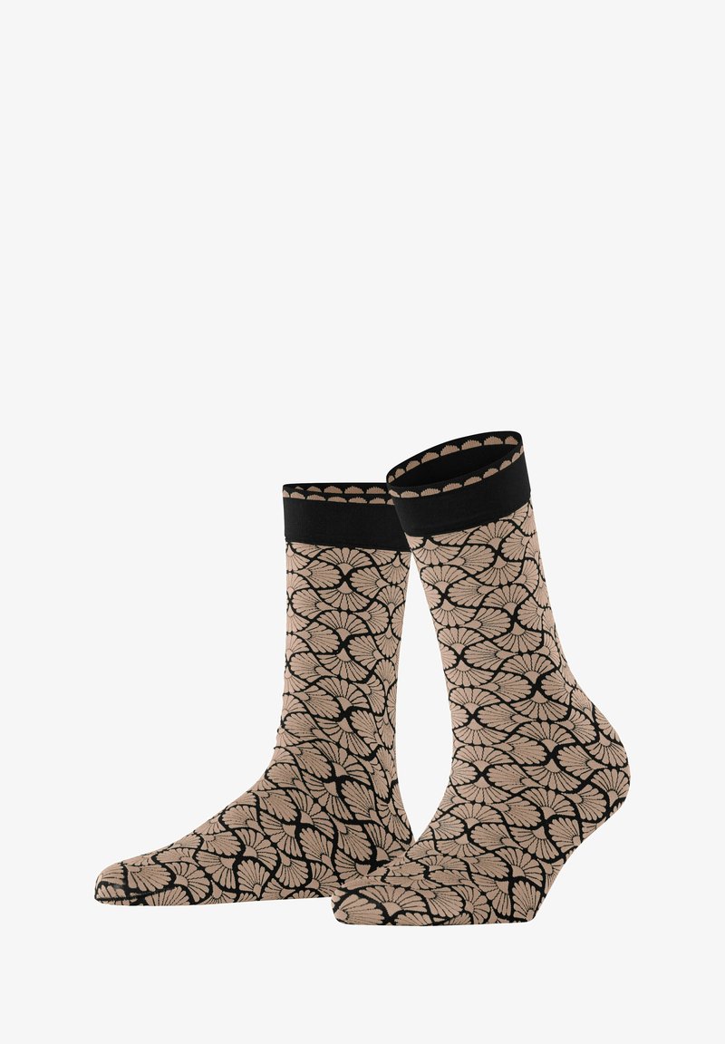 Beige Knöchelsocken mit einem schwarzen Blumenmuster, die einen einfarbigen schwarzen Bund und eine glatte Textur aufweisen.