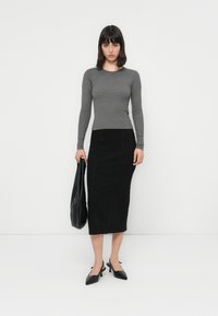 Gray long-sleeve fitted top, black denim pencil skirt, black slingback heels, and a black tote bag; smooth textures and simple lines.