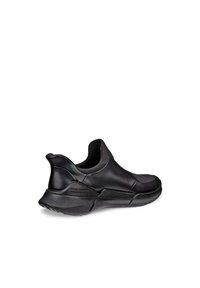 Pantofii negri tip slip-on, cu un superior din piele netedă, guler curbat și talpă texturată. Au cusături minime și un design ușor.