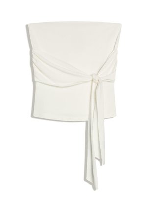 Biely crop top bez ramienok s širokým pásom zviazaným vo voľný uzol vpredu, ktorý asymetricky visí dolu.