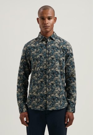 Langarmshirt van stof met een donkerblauwe achtergrond en een bloemenpatroon in beige en lichtblauwe tinten. Met knopen.