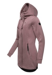 Long pink hooded jacket with a structured design, zipper pockets, ribbed texture, and black hardware accents.