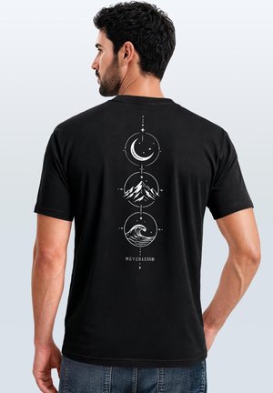 Man in black T-shirt with white graphic showing moon, mountain, and wave symbols stacked vertically with the word "NEVERLESS" below.