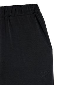 Black jogger pants with an elastic waistband, side pockets, and a subtle embroidered logo. Soft, smooth fabric texture.