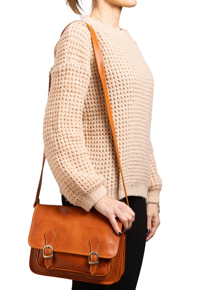 Borsa a tracolla in pelle marrone con pattina, due fibbie frontali e cuciture in contrasto. Tessuto liscio con una forma strutturata.
