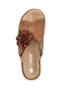 Brown leather slide sandal with crossover straps, cushioned footbed, and a flower accent on the side. Textured surface and flat sole.