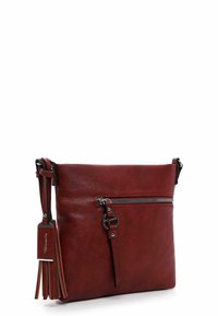 Red leather crossbody bag with a smooth texture, featuring a front zipper pocket, decorative tassel, and metal hardware accents.