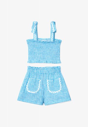 Blauw-wit geruit crop top met smockwerk, geruite gerimpelde bandjes en bijpassende shorts met hoge taille, voorzakken met witte bies.
