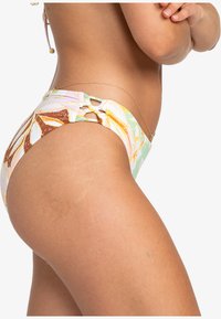 High-waisted bikini bottom with a floral pattern in pastel colors, featuring side cutouts and a gold chain accent along the waist.