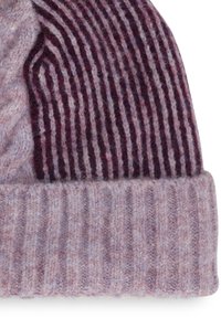 Knit hat in muted purple tones with a textured pattern; features ribbed bottom and striped top section, made of soft wool material.
