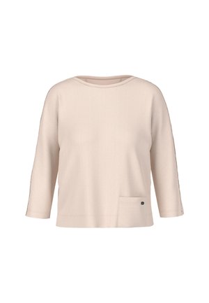 Light beige pullover top with three-quarter sleeves, a rounded neckline, and a front pocket with a small logo detail. Soft, textured fabric.