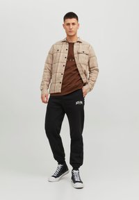 Jack & Jones JPSTKANE JOSH - Tracksuit bottoms - black