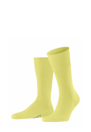 Gelbe Baumwollsocken mit geripptem Bündchen und glatter Textur. Verfügen über ein nahtloses Design und eine verstärkte Zehenpartie, mit dem Markennamen auf der Sohle etikettiert.