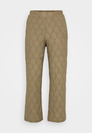 Khaki pants with a textured, diamond pattern and small cutouts. Features a wide elastic waistband and a straight leg design.
