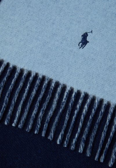 Soft blue and navy scarf with fringed edges and a small embroidered navy polo player logo near the top.
