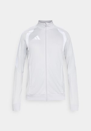 Svetlosivá tréningová bunda na zips s bielymi detailmi, vybavená vysokým golierom, dlhými rukávmi a dizajnom s tromi pruhmi na ramenách.