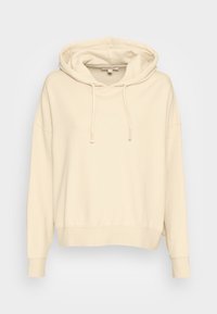 Beige hoodie i mjuk bomullsblandning, med långa ärmar, en stor huva, snören och ribbad nederkant för en avslappnad passform.