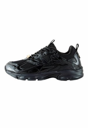 Black sneaker with mixed mesh and shiny panels, lace-up closure, thick sole, and pull tabs at heel and tongue, side view.