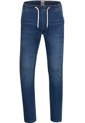 Pantalones jogger de mezclilla con cinturilla elástica, cordón y corte ajustado. Presentan un color azul oscuro y detalles de costura sutiles.