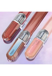 Three lip glosses feature clear, oval containers with silver caps. Colors include a reddish-brown, a soft pink, and a peachy shade with shimmer.